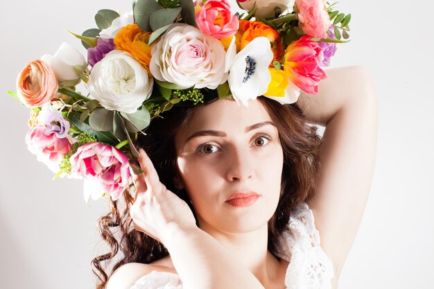 Close up face of beautiful woman in flower wreath on hairstyle