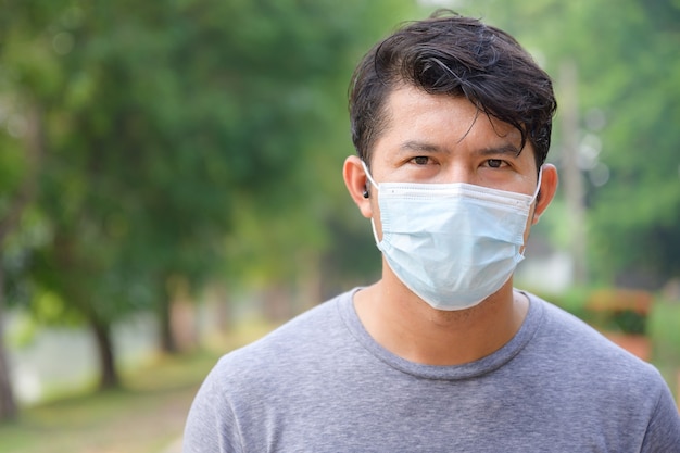 Close-up face focus Asian handsome young man People who sweat from morning exercises and wear a mask with SARS-cov-2.