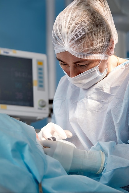 Close up of the face of a patient who is undergoing blepharoplasty The surgeon cuts the eyelid and performs manipulations using medical instruments