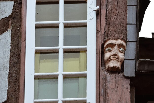 Close-up of faces wood carved in old houses in rochefort-en-terre french brittany