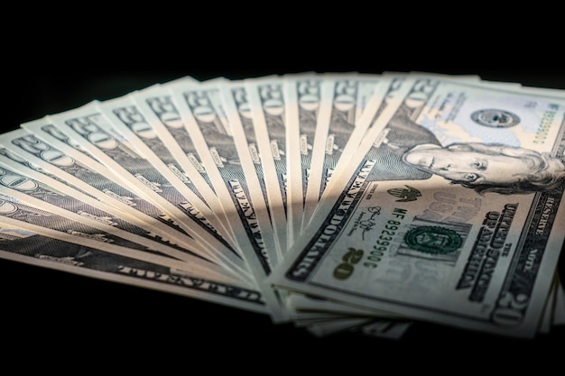 Photo close-up of fanned out paper currencies over black background