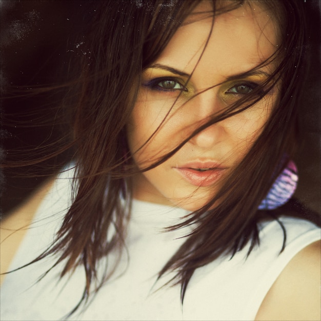 Close up fashion art portrait of beautiful brunette young woman posing in white dress. 