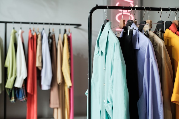 Close-up of fashion colored shirts hanging on the rack in the store