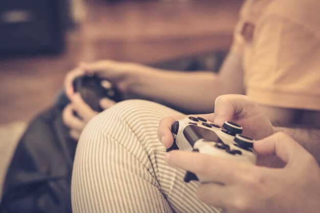 Close-up of father and son playing video games at home
