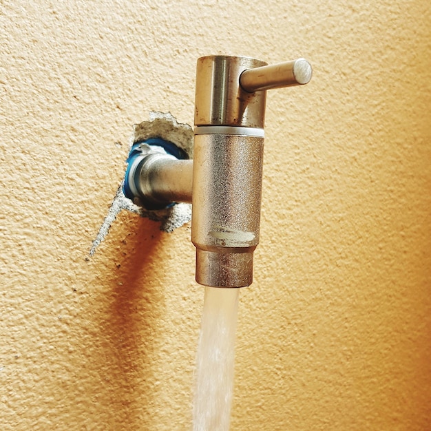 Close-up of faucet against wall