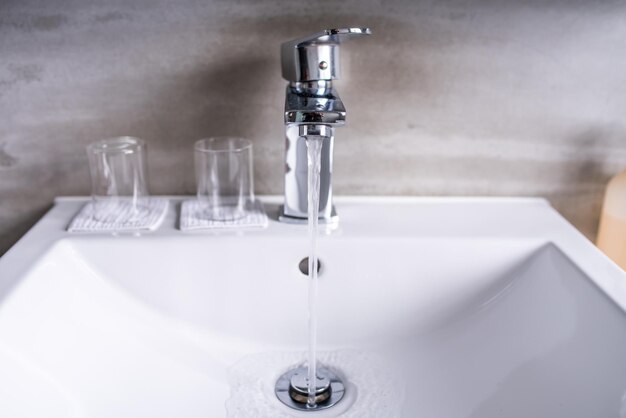 Photo close-up of faucet in bathroom at home