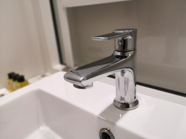 Close-up of faucet in bathroom