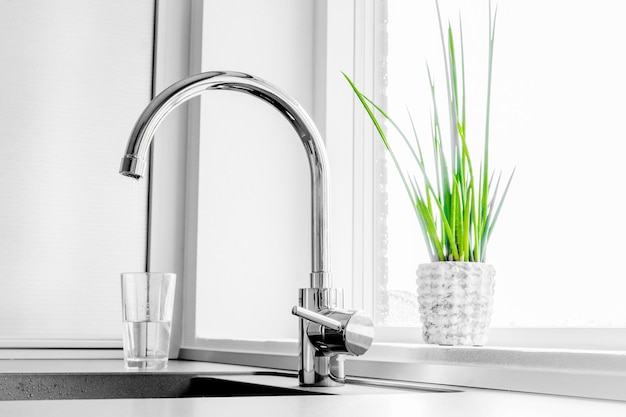 Close-up of faucet by window at home