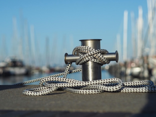 Close-up of faucet on pier against sky