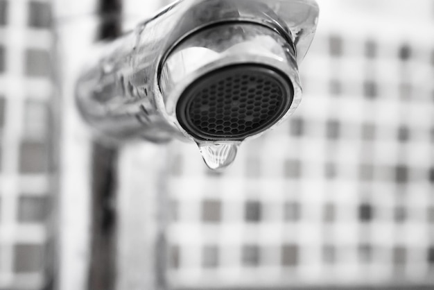 Photo close up faucet with water drop