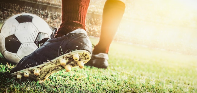 Close up feet of soccer football player dribbling the ball in stadium during match