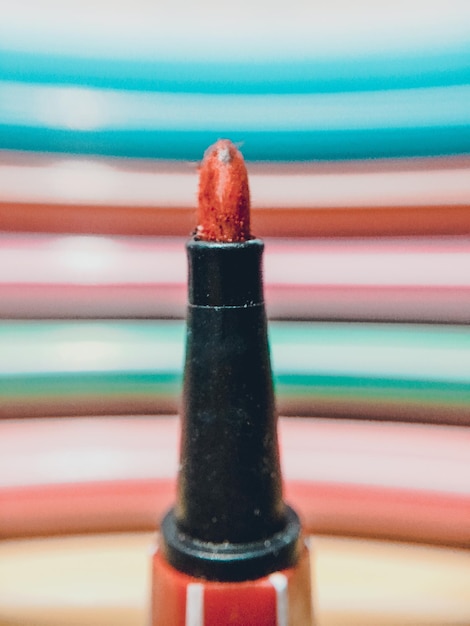 Photo close-up of felt tip pen with colorful stripes in backgrounds