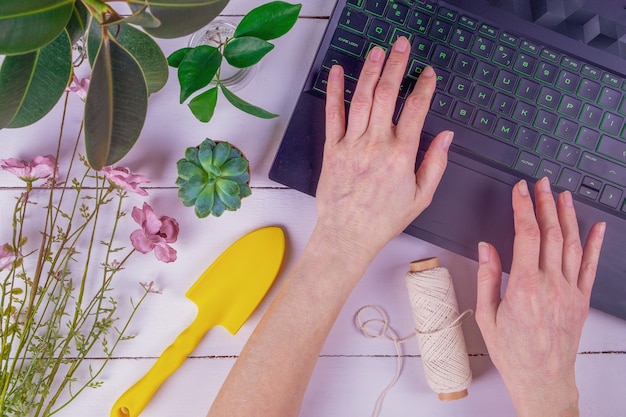 Close-up of female adult hands are typing on a laptop keyboard.