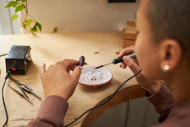 Close up of female artist shaping wax molds