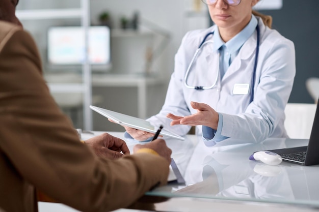 close up of female doctor holding tablet
