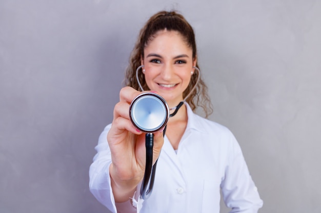 Close-up of female doctor using stethoscope