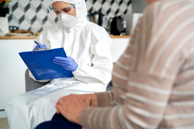 Close up of female doctor visiting a senior at home