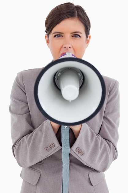 Close up of female entrepreneur shouting through megaphone