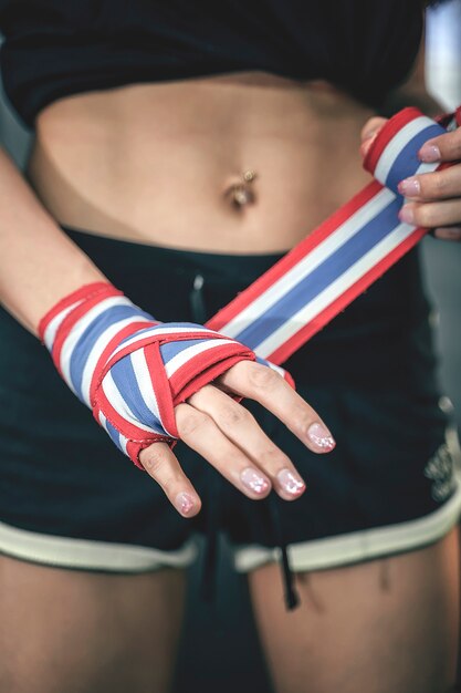 Close up female fighter hand using handkerchiefs