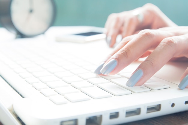 Close up of female fingers using laptop, Working woman and Online shopping concept