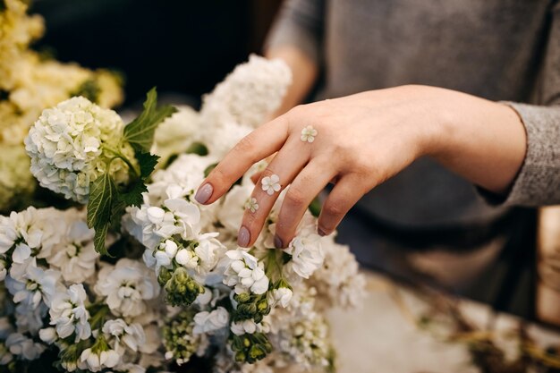 Close-up of female florist hands making bouquet