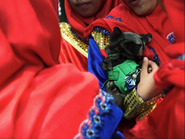 Close-up of female friends holding red bell