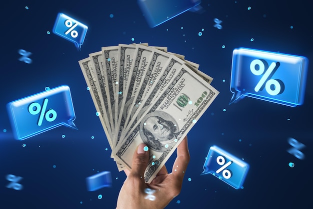 Close up of female hand holding dollar bills on blue background Money and investment growth rate promotion and sale concept