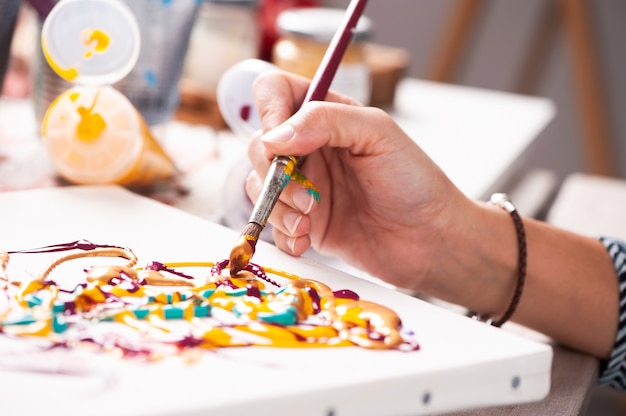 Close up of a female hand painting