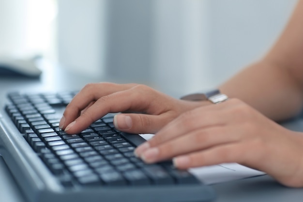 Close-up of female hand typing on keyboard