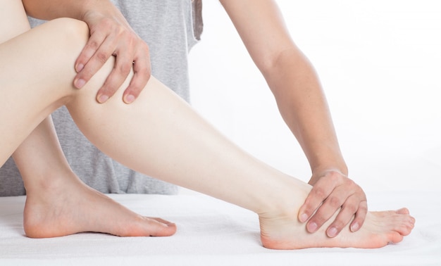 Close-up of female hands doing foot massage