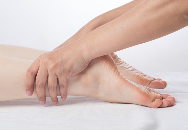 Close-up of female hands doing foot massage