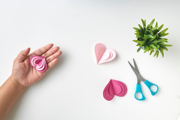 Close up on female hands holding a pink heart presents for valentine day, birthday, mother