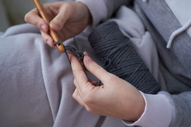 Close-up of female hands knitting crochet.