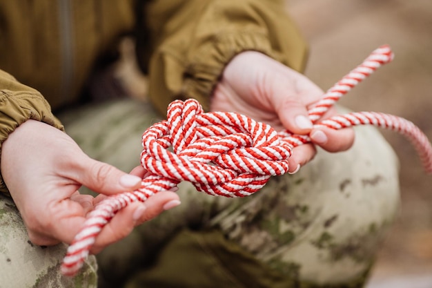 Close up of female hands tie a rope