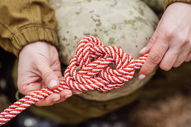 Close up of female hands tie a rope