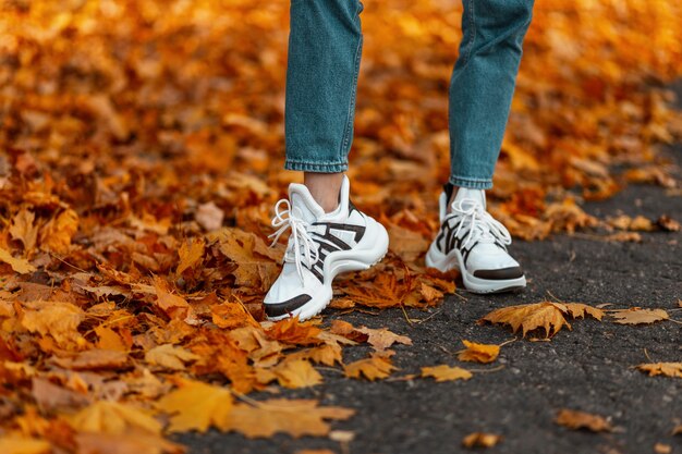 Close-up of female legs in blue fashionable jeans