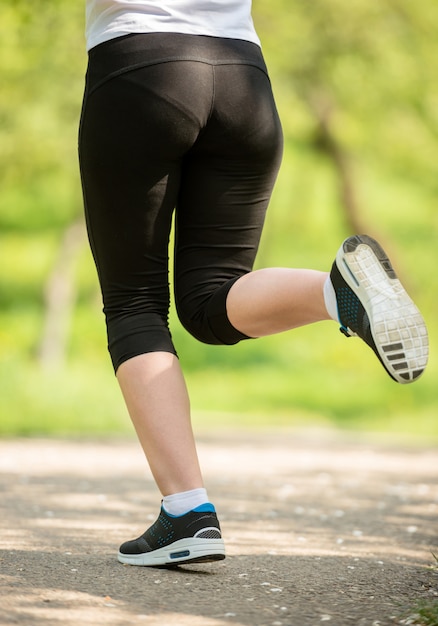 Close-up of female legs in sneakers.