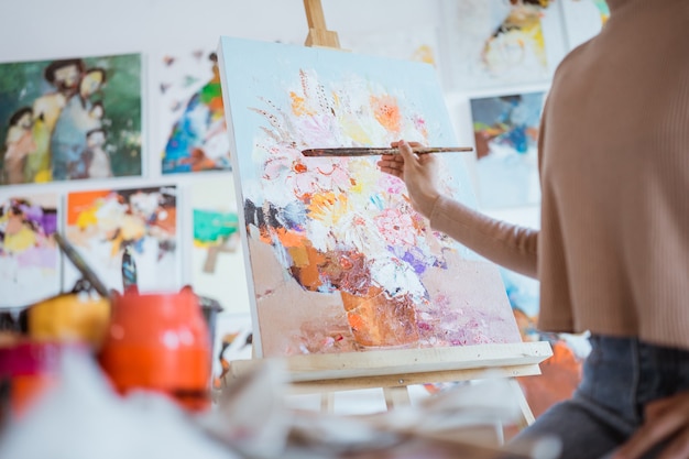 Close up of female painters hand holding a paint brush