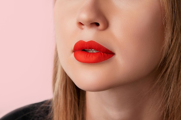 Close up female plump lips with red matte lipstick beauty fashion portrait personal care and make up