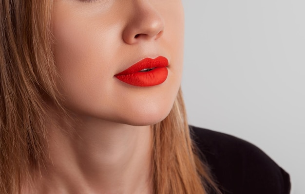 Close up female plump lips with red matte lipstick beauty fashion portrait personal care and make up