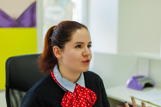 Close-up of female receptionist at table in hotel