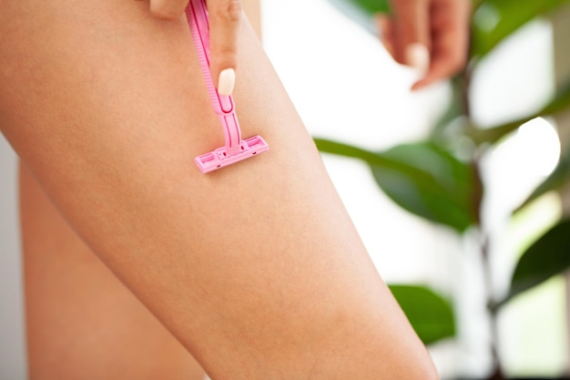 Close up of female that shaving her legs