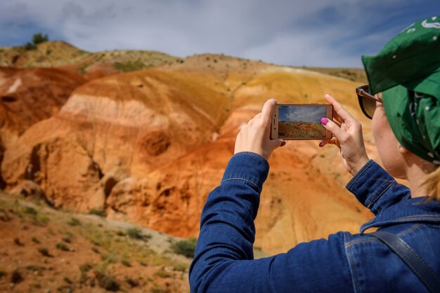 Primo piano del turista femminile spara incredibile fenomeno naturale sul suo smartphone.