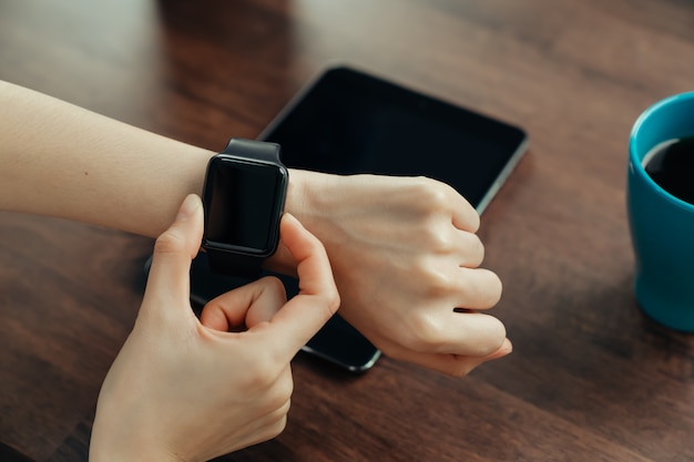 Close-up of female wearing in smart watch application.