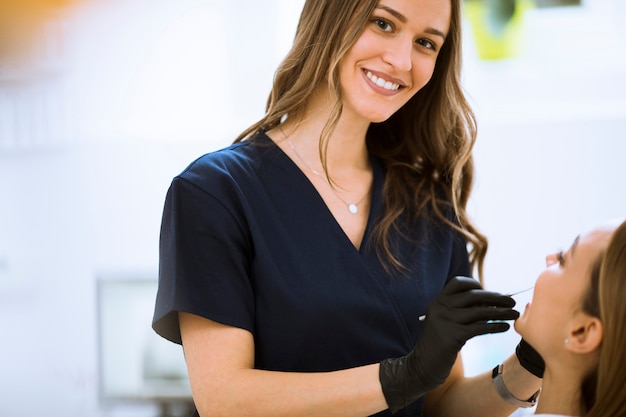 Close-up of female with open mouth during oral checkup at the dentist