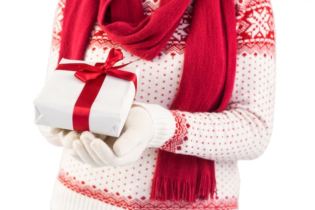 Close up of a festive brunette holding a gift