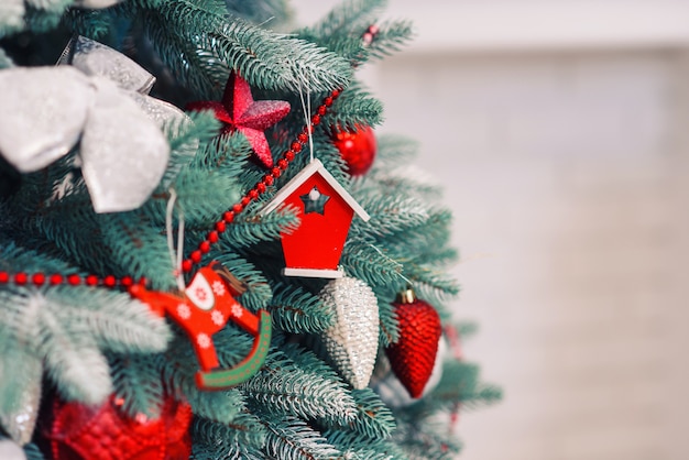 Close up festive decorated christmas tree with colorful bright toys.