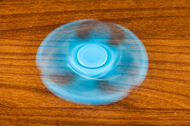 close-up of fidget spinner spinning on table