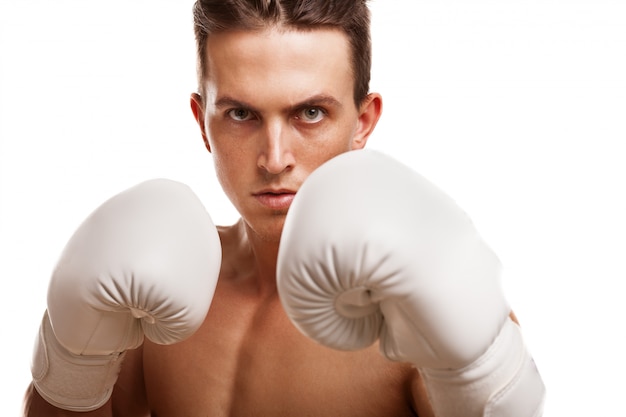 Close up of a fierce male boxer holding up his fists in boxing gloves