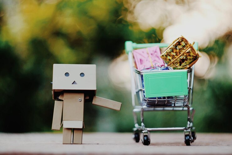 Photo close-up of figurine and gifts in shopping cart on table